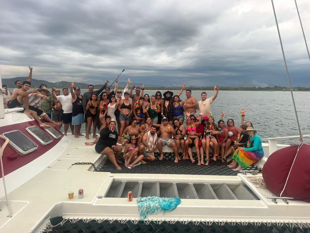 A group of people smiling and posing on a boat
