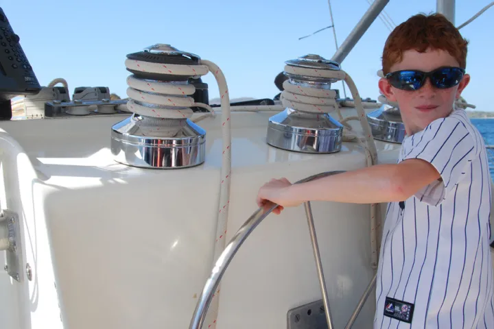 kid steering boat