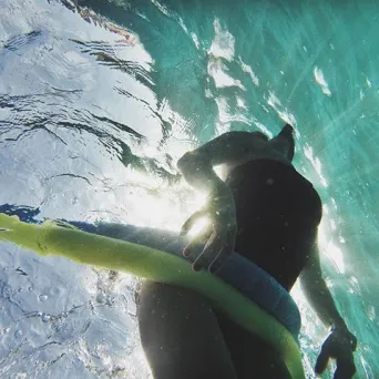Girl underwater with noodle