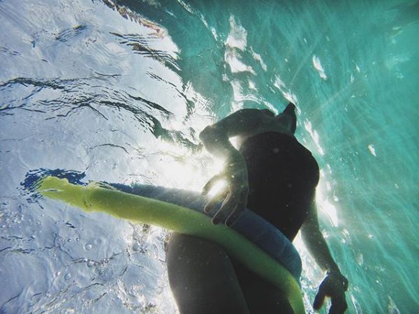 Girl underwater with noodle