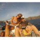 Tourists sunbathing on catamaran
