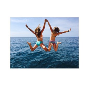 Girls jumping into water
