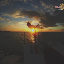 Girl on catamaran at sunset