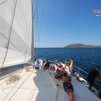 People sunbathing on catamaran tour
