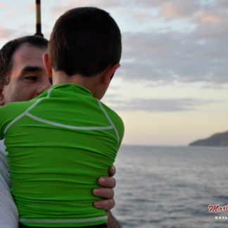Boy with father sailing tour